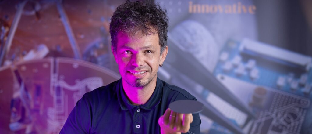 Giordano Scapucci balancing a germanium wafer on his finger