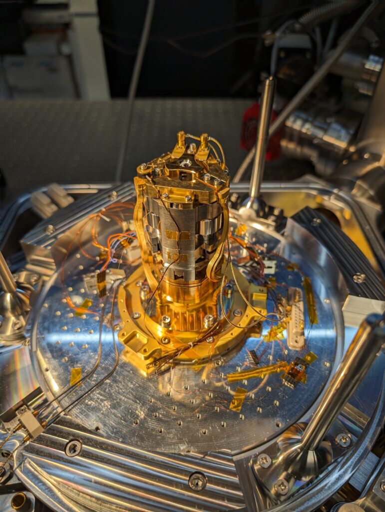 The inside of the cryostat used for the experiments. The cylindrical stack is the positioning system that controls the microcavity system at its top.